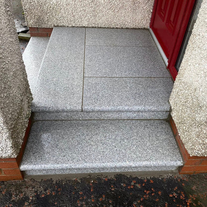 Silver Granite Steps leading up to a red door. 