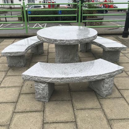 Silver Granite Table & Bench Set in a public rea. 