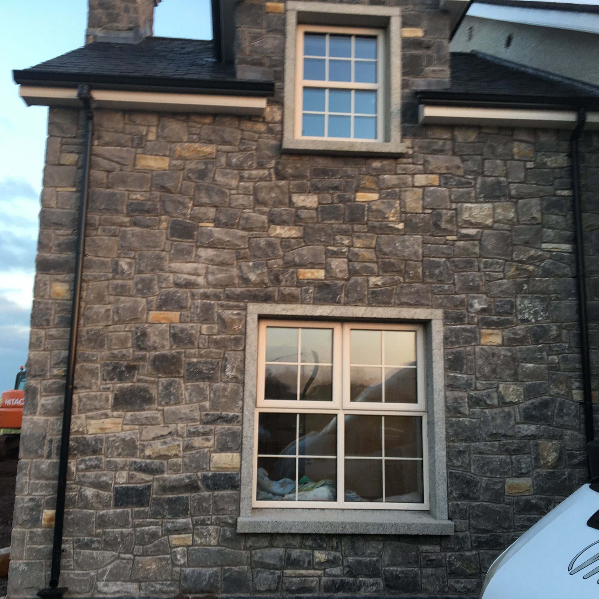 Stone building façade with bespoke window surrounds. 