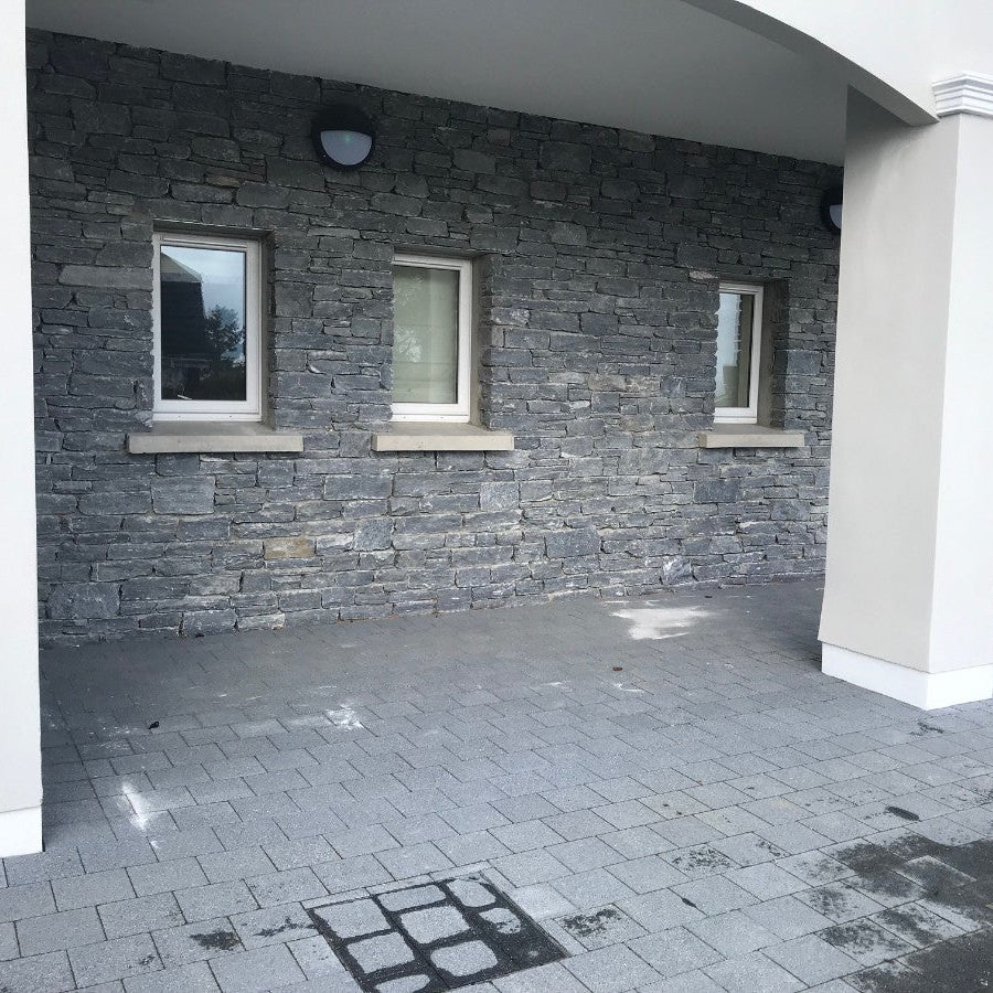 External stone façade in Silver Shale machined walling stone. 