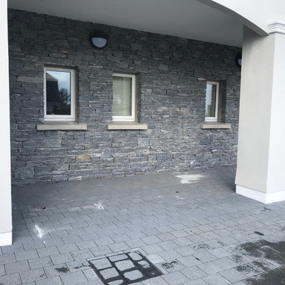External stone façade in Silver Shale machined walling stone. 