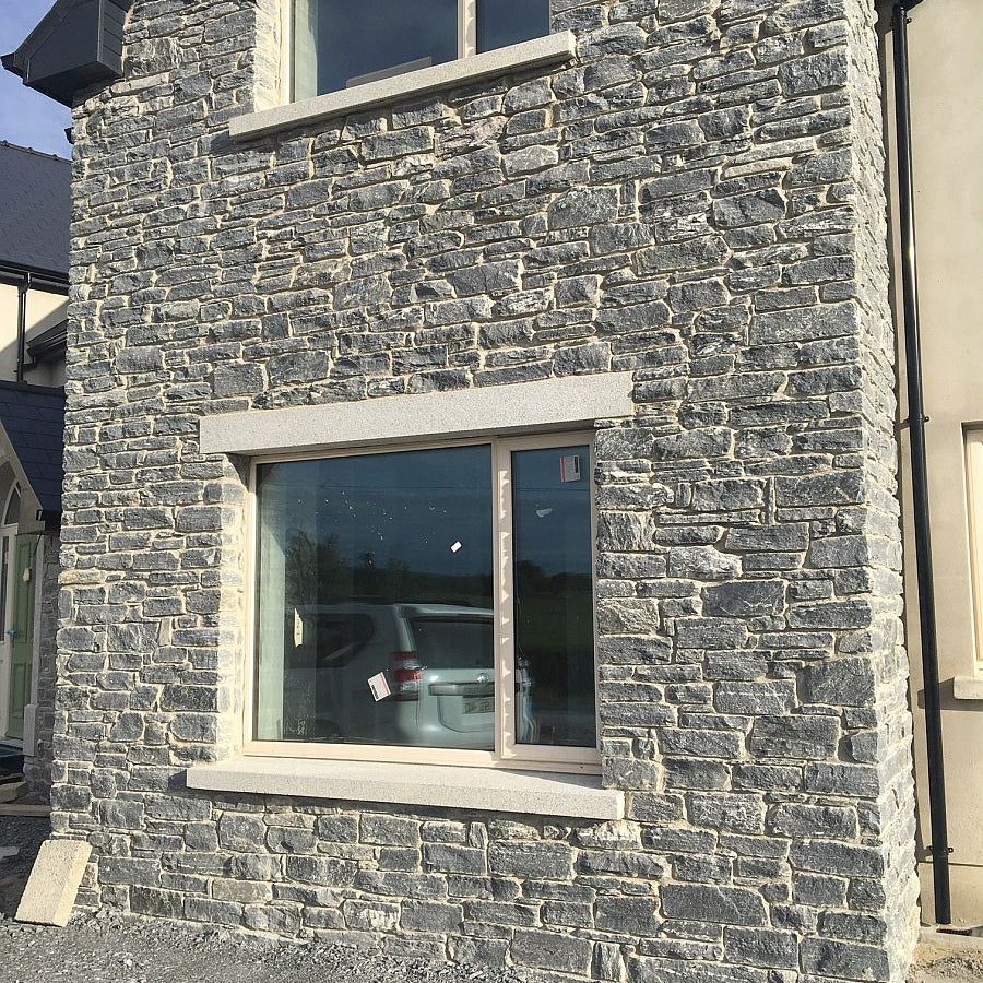 Close up of a new build with a stone façade in Donegal Schist walling stone.