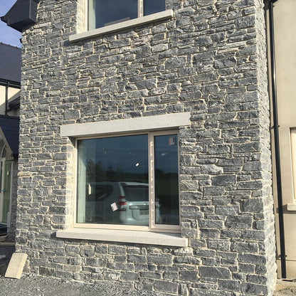 Close up of a new build with a stone façade in Donegal Schist walling stone.