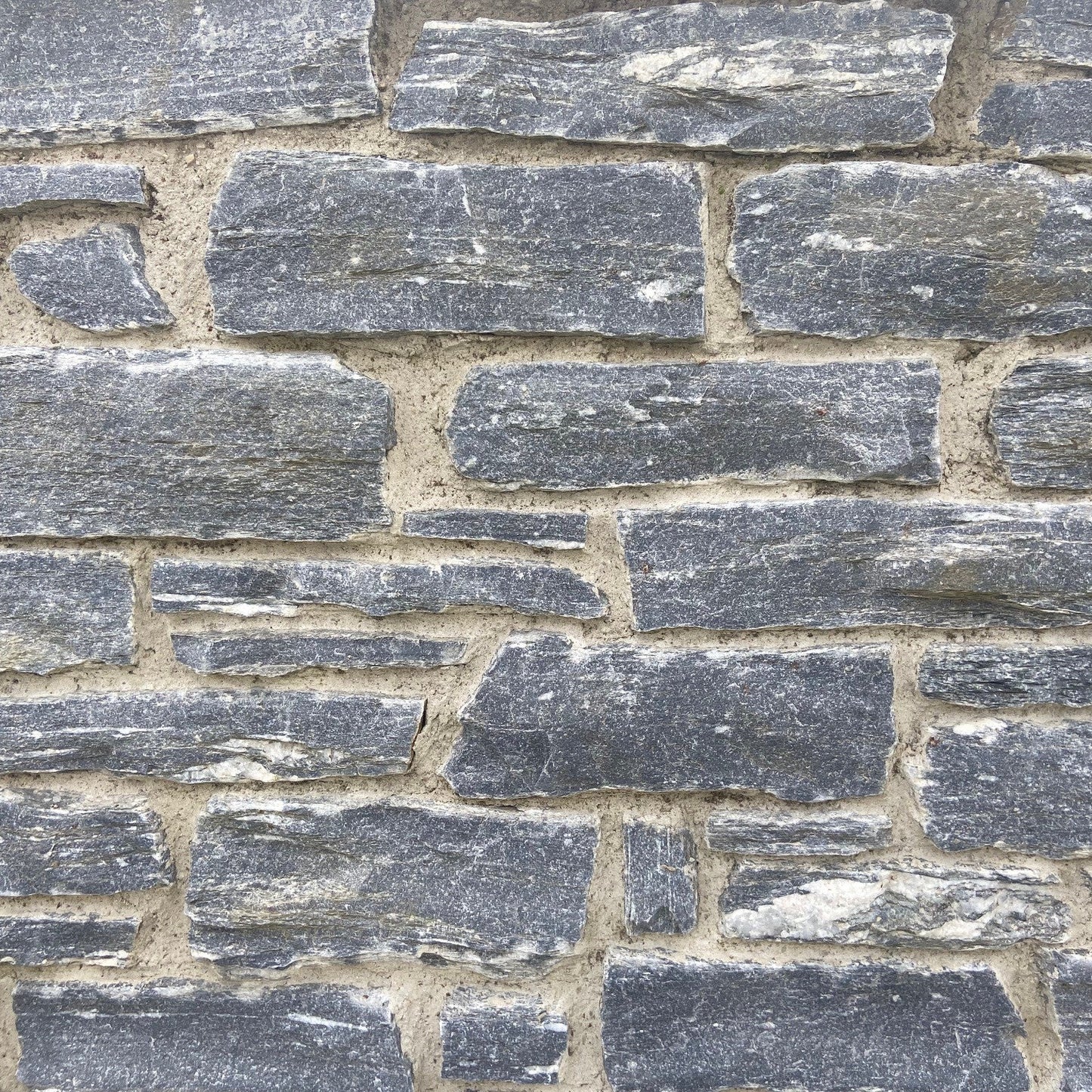 Close-up of a stone wall with grey Silver Shale Machined walling stones