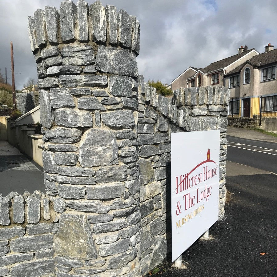 Boundary wall in Silver Shale Machined walling stone leading into a residential area. 