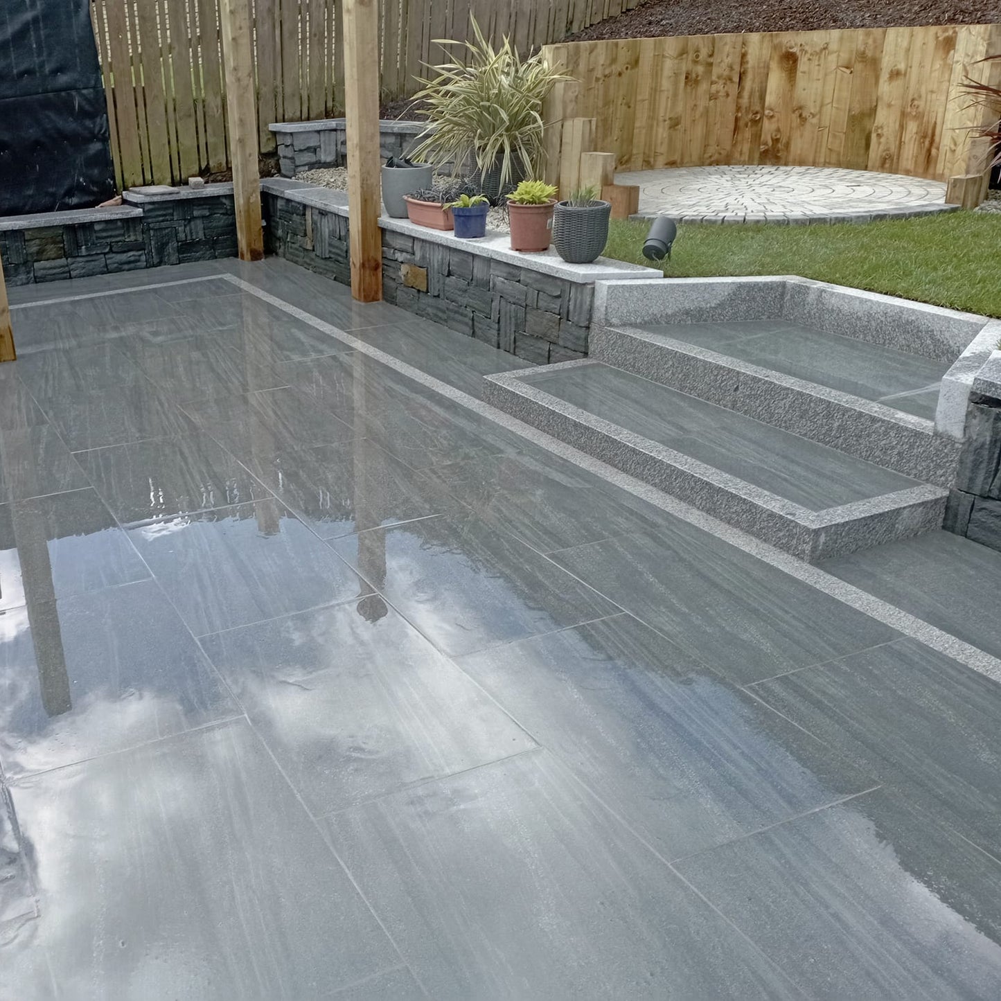 Patio area featuring Smokey Jewel Range Porcelain Paving. 