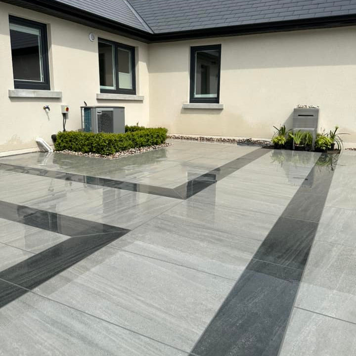 Patio area completed with two porcelain paving tiles. The darker design is Smokey Jewel Range Porcelain Paving. 