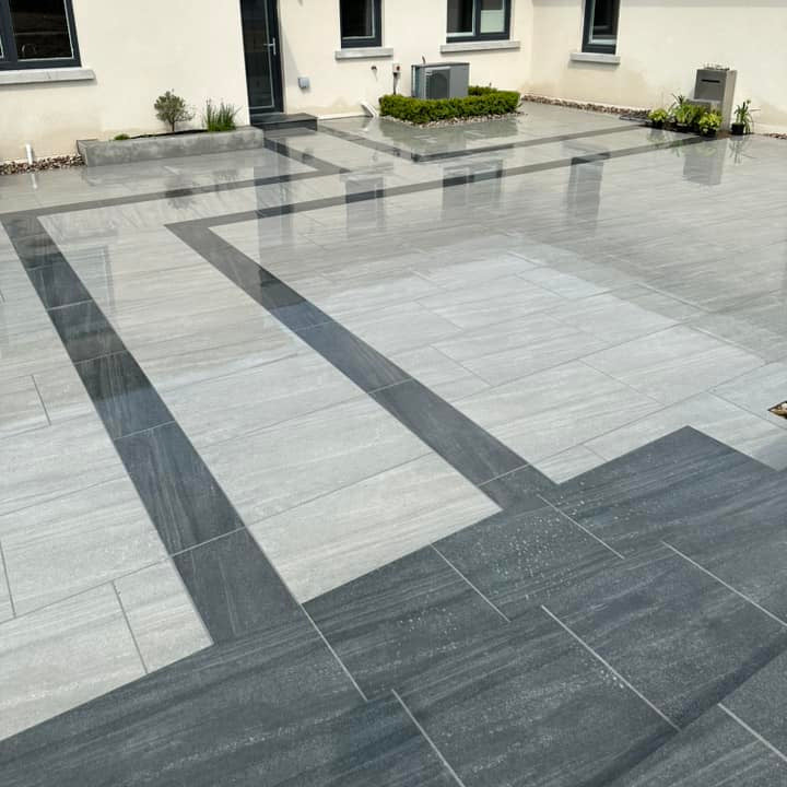 Patio area completed with two porcelain paving tiles. The darker design is Smokey Jewel Range Porcelain Paving. 