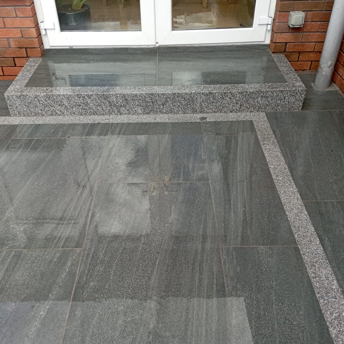 Close up of patio paving ad step finished using Smokey Jewel Range Porcelain Paving Tiles. 