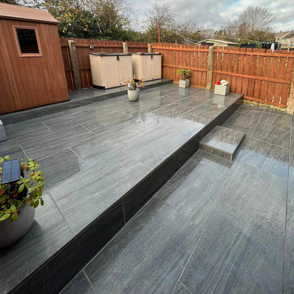 Raised patio area completed using Smokey Jewel Range Porcelain Paving. 