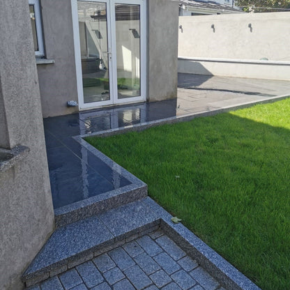 Pathway leading to patio area completed in Station Black Jewel Range Porcelain Paving. 