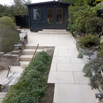 Patio area and steps featuring Station White Porcelain Paving being installed. 