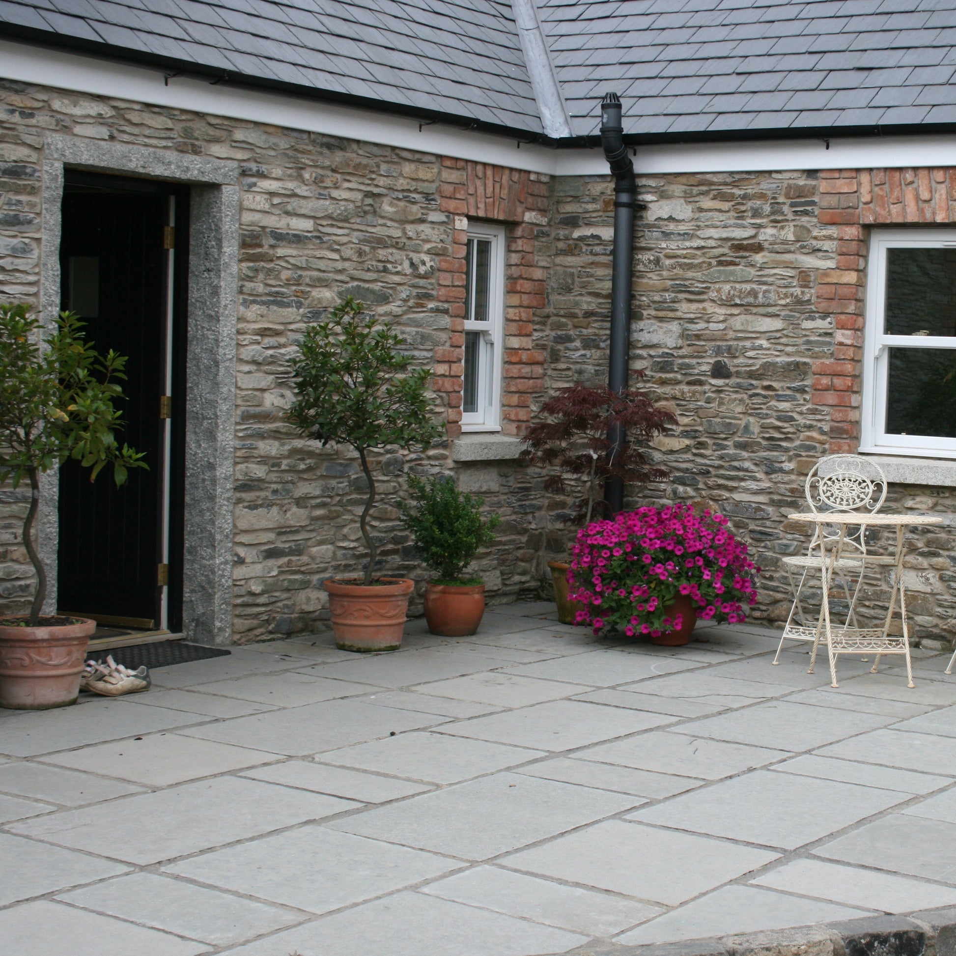 Traditional cottage with T-Grey Limestone Paving in Mixed Sizes. 