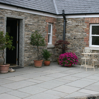Traditional cottage with T-Grey Limestone Paving in Mixed Sizes. 