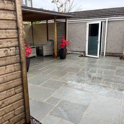 Backyard featuring T-Grey Limestone Paving in mixed sizes. 