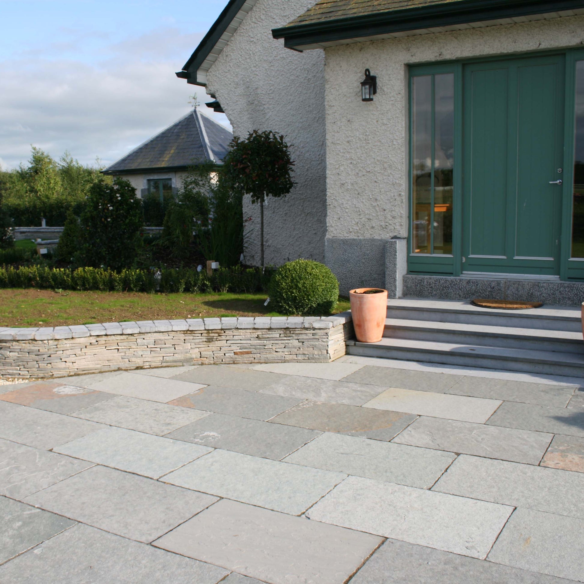 Front entrance with steps and paving in T-Grey Limestone. 
