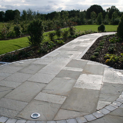 Garden paths with unique circular design completed using T-Grey Limestone Patio Packs. 