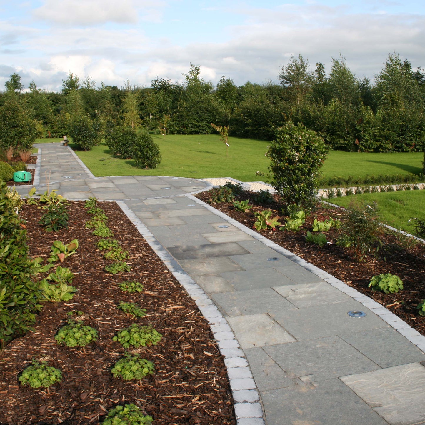 Well maintained garden with stone pathways in T-Grey Limestone paving. 