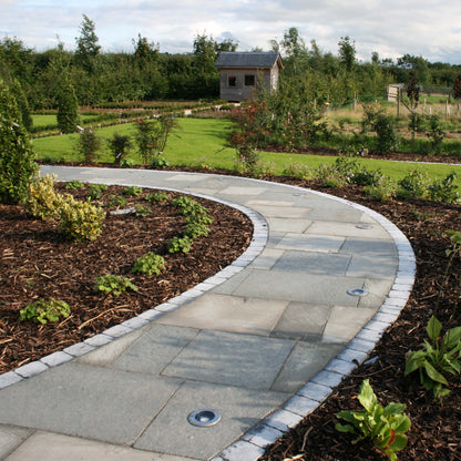 Curved garden path completed using T-Grey Limestone Paving in mixed sizes. 