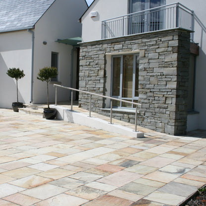 Modern house with patio area to the front featuring Tinted Mint Sandstone paving. 
