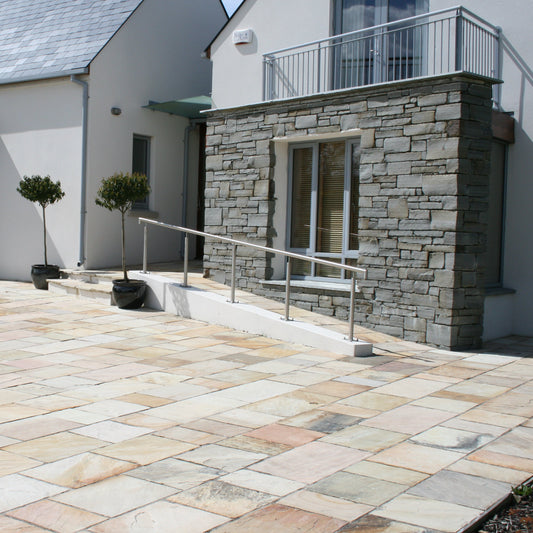 Modern house with patio area to the front featuring Tinted Mint Sandstone paving. 