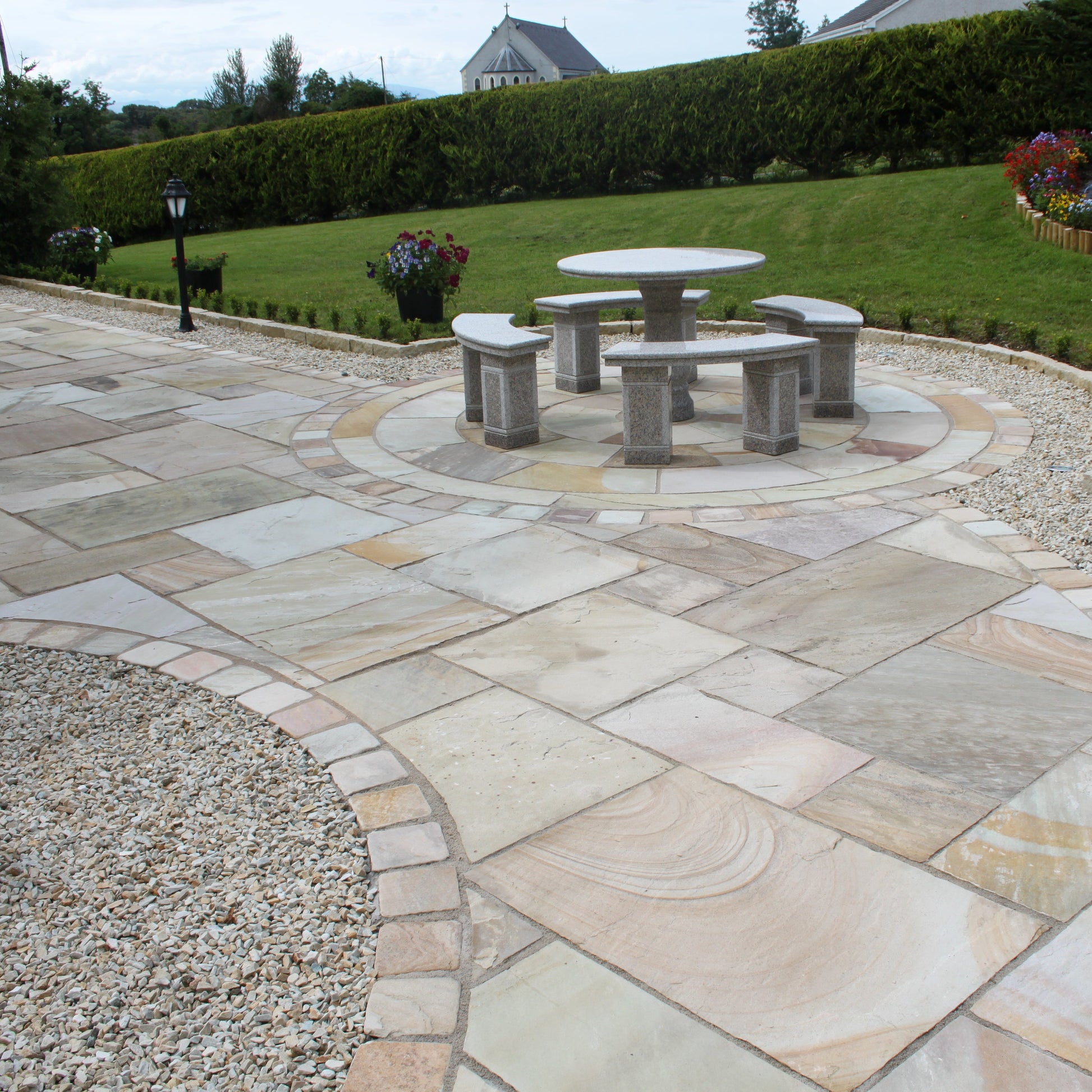 Garden and Patio area completed using Tinted Mint Sandstone Paving, Circle, kerbing and Cobbles. 