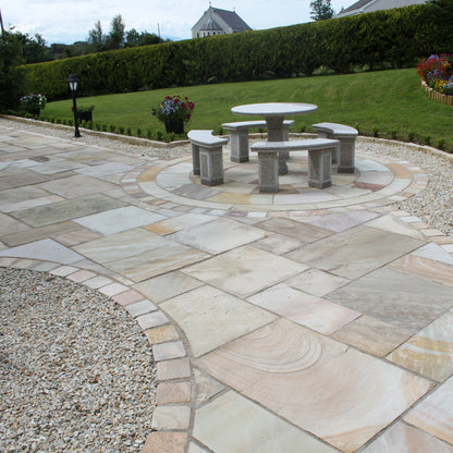 Garden and Patio area completed using Tinted Mint Sandstone Paving, Circle, kerbing and Cobbles. 