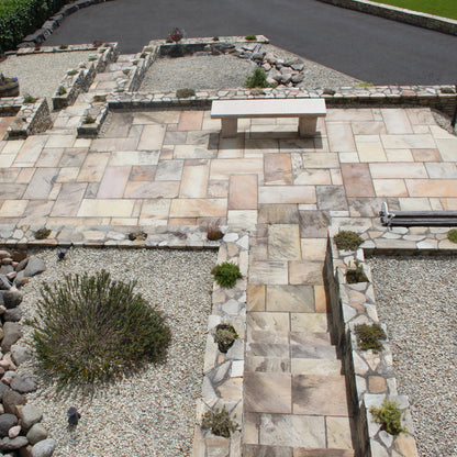 Overhead view of raised patio area with steps featuring Tinted Mint Sandstone paving. 