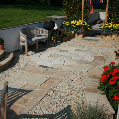Pathway featuring Tinted Mint Sandstone Paving and Circle, surrounded by natural stone chipping and planting. 