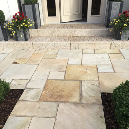 Pathway in Tinted Mint Sandstone Paving leading towards a house entrance. 