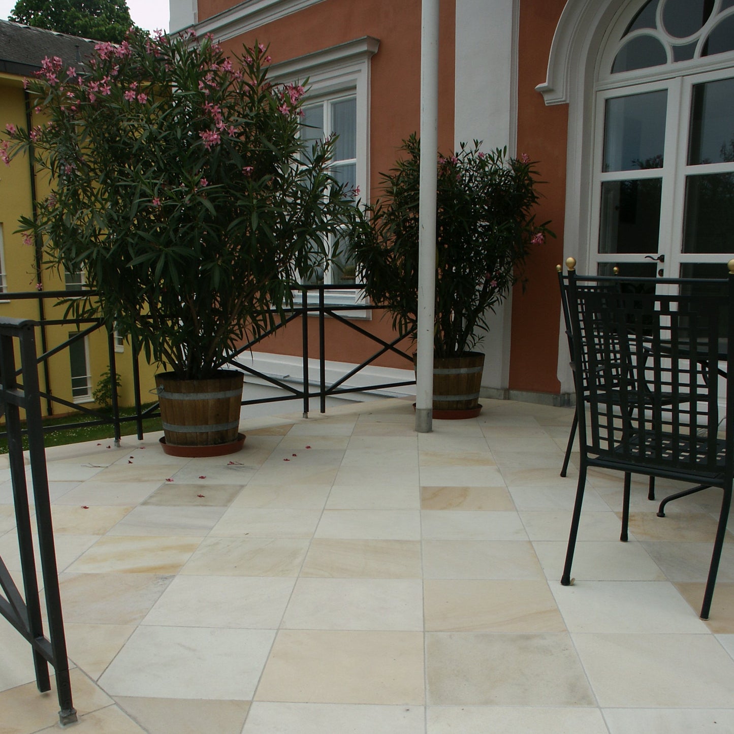 Outdoor patio paved using Tinted Mint Sandstone Paving in 600 x 600mm size.  