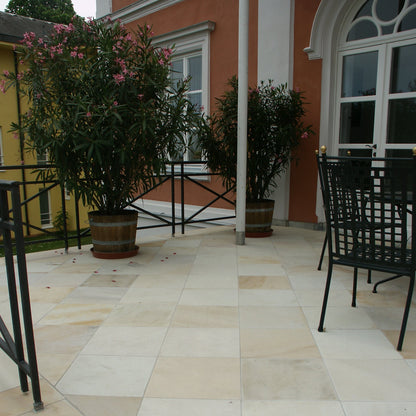 Outdoor patio paved using Tinted Mint Sandstone Paving in 600 x 600mm size.  