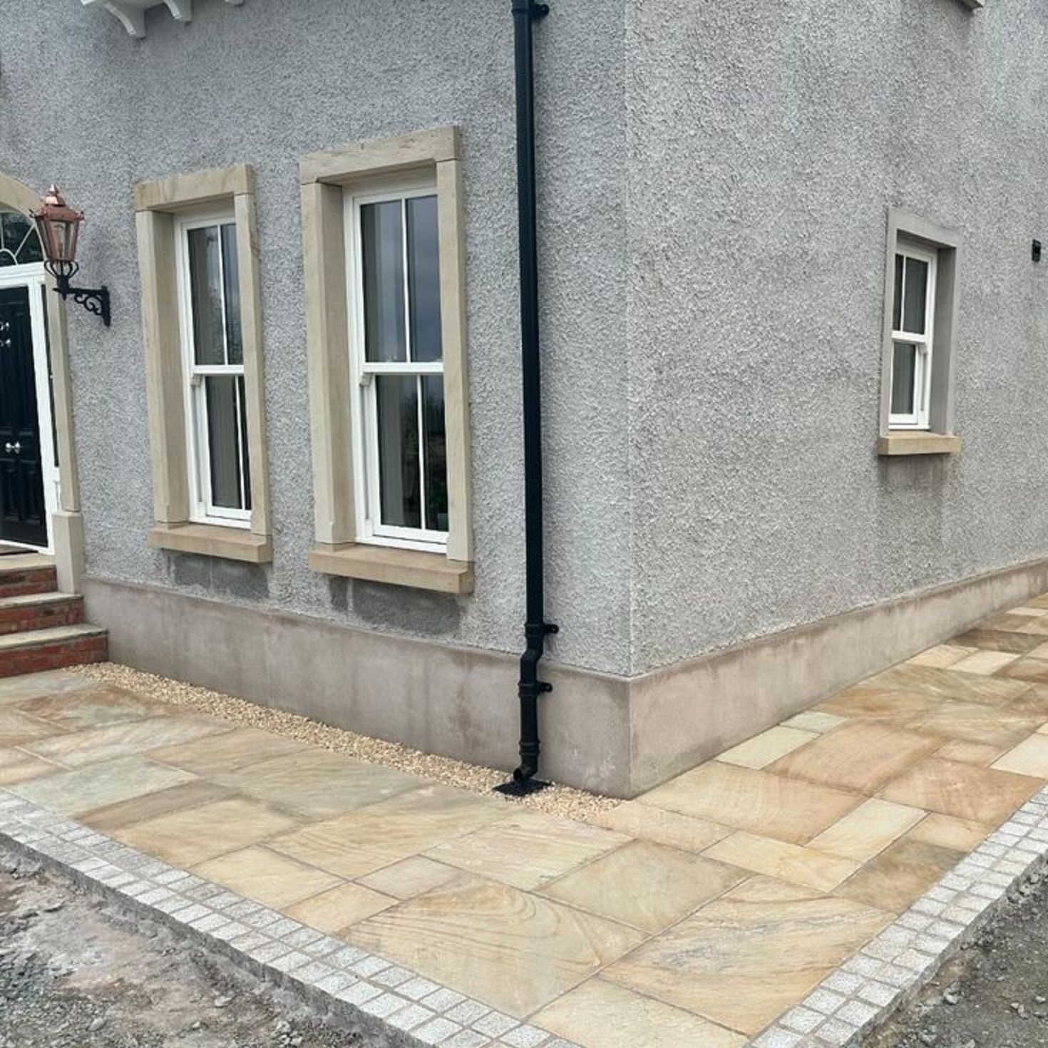 Path featuring Tinted Mint Sandstone paving in mixed sizes. 