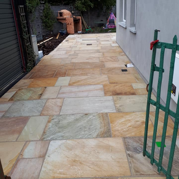 Stone paved area leading to rear of house completed using Tinted Mint Sandstone patio packs.