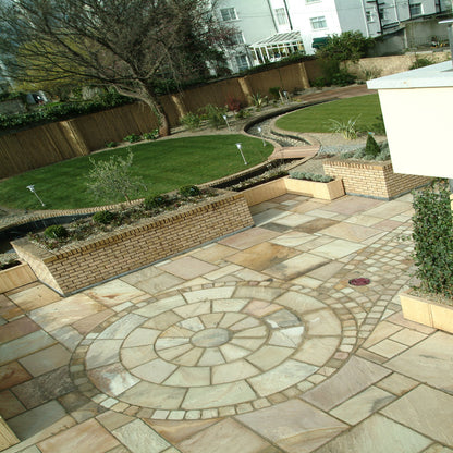 Large patio featuring 3m Tinted Mint Sandstone Circle with matching Tinted Mint Sandstone Patio Pack Paving and Cobbles. 