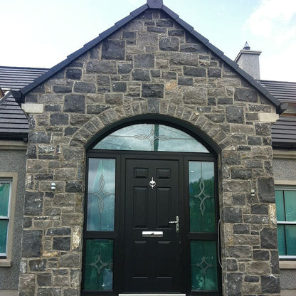 Stone porch with black door. Stone is white limestone machined walling stone. 