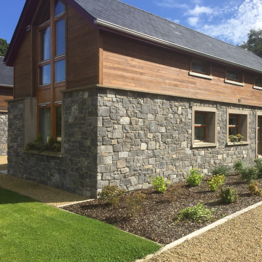 Stone building in white limestone machined walling stone and wood. 