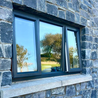 Close up of a window and wall cladded in White Limestone Stoneer Cladding. 