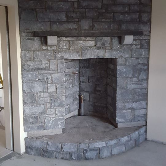 Internal stone fireplace completed using white limestone stoneer cladding.