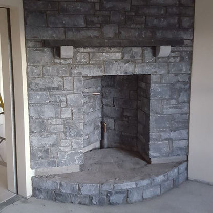 Internal stone fireplace completed using white limestone stoneer cladding.