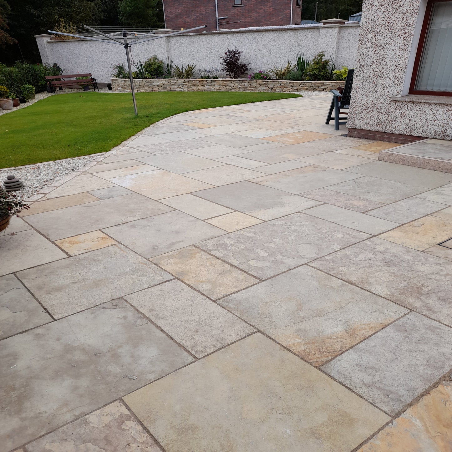 A completed patio installation using Yellow Limestone Patio Pack in a machine cut finish.