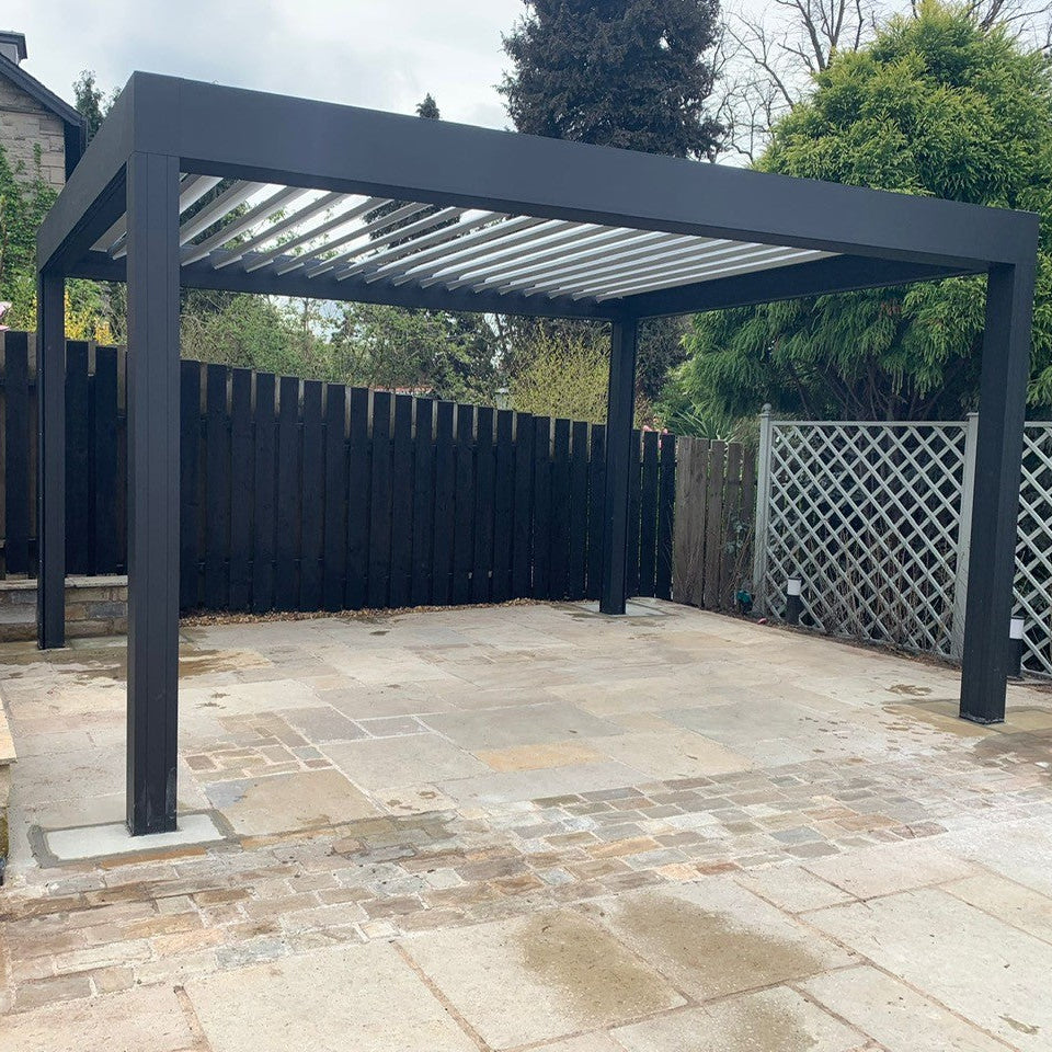 Metal pergola over patio completed using Yellow Limestone Paving in tumbled patio pack sizes and cobbles. 