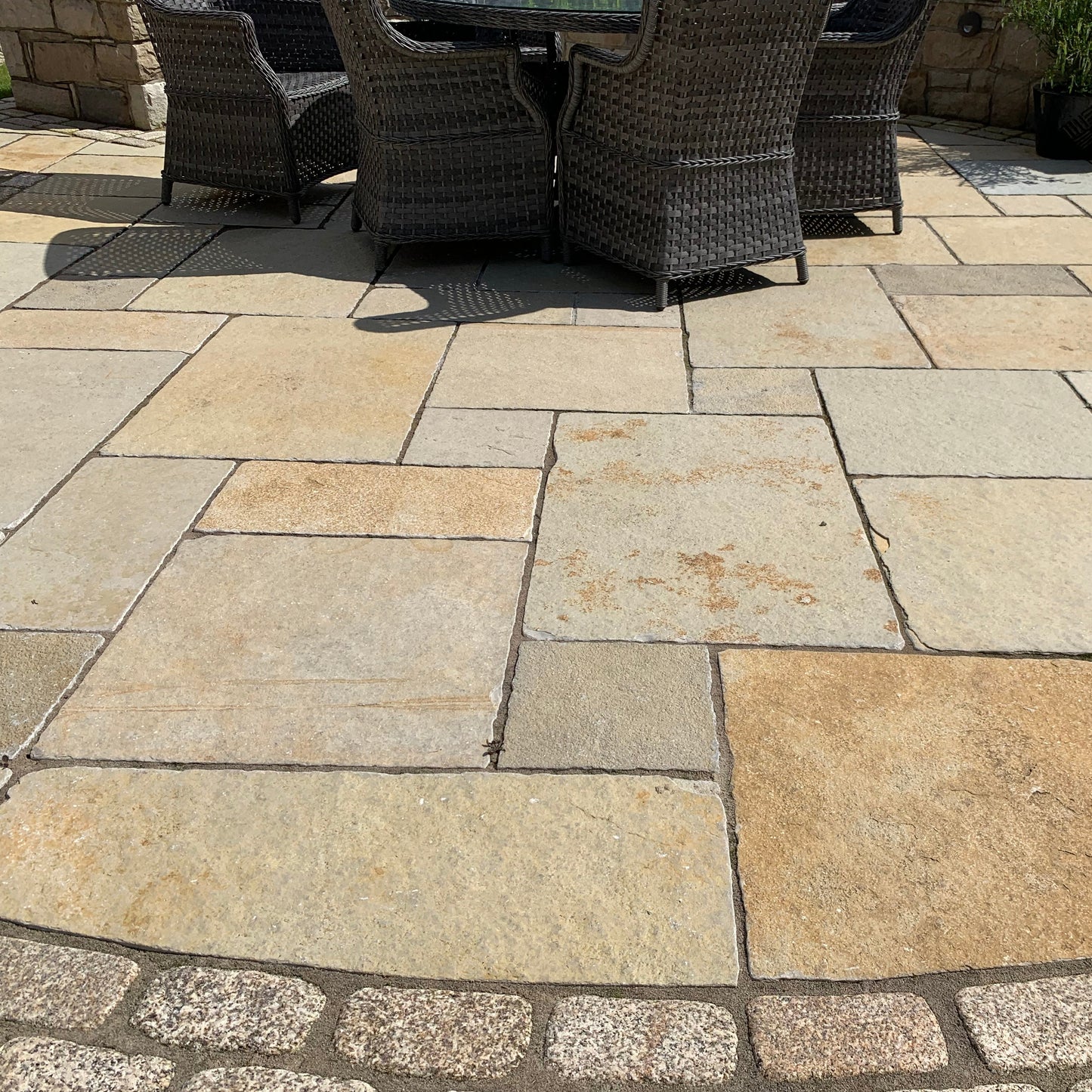 Patio area featuring Yellow Limestone Tumbled paving and Gold Granite Cobbles. 